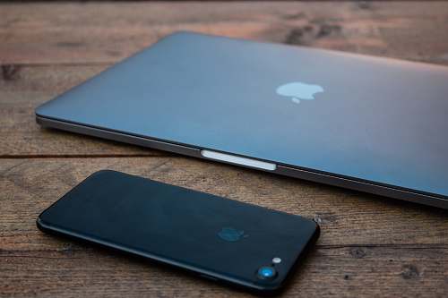 electronics shallow focus photo of jet black iPhone 7 on brown wooden surface mobile phone